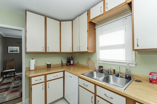 kitchen with a sink, light countertops, and dishwasher