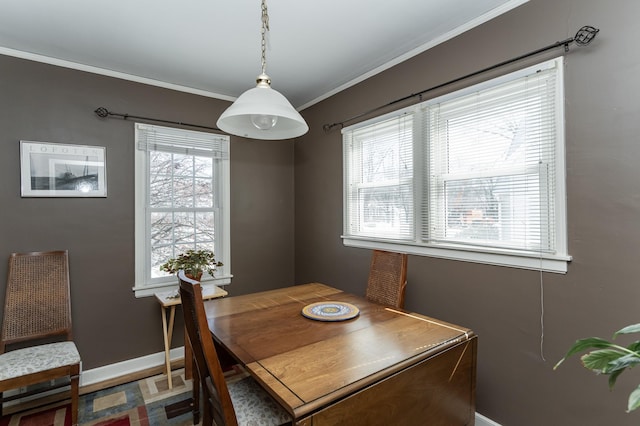 dining area featuring ornamental molding and baseboards