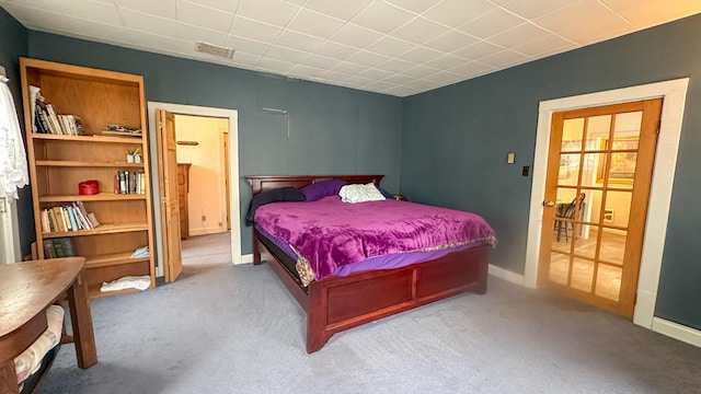 bedroom featuring visible vents, baseboards, and carpet