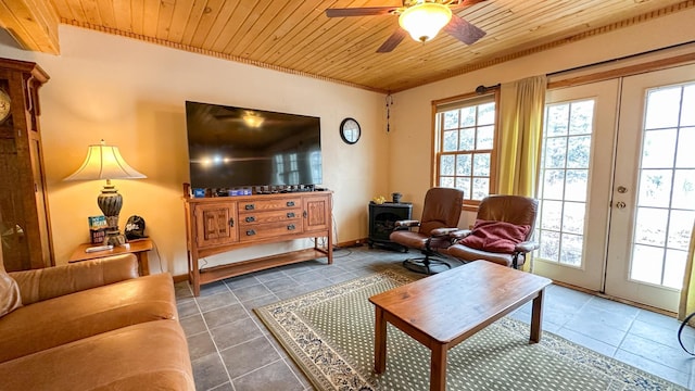 living area featuring tile patterned floors, french doors, wood ceiling, and a ceiling fan