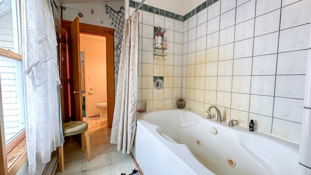 full bathroom with toilet and tile walls