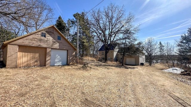 detached garage featuring driveway