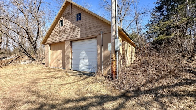 detached garage featuring driveway