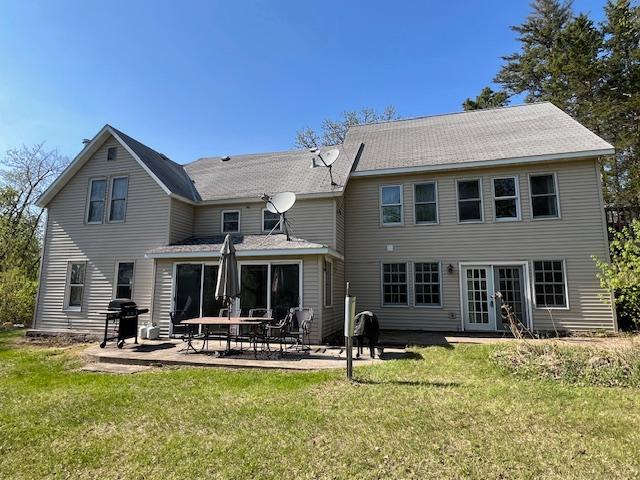 28503 Ottawa Dr, Browerville, MN 56438 - back of house with french doors, a lawn, and a patio