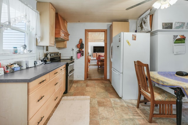 28503 Ottawa Dr, Browerville, MN 56438 - kitchen with double oven range, custom range hood, freestanding refrigerator, dark countertops, and ceiling fan