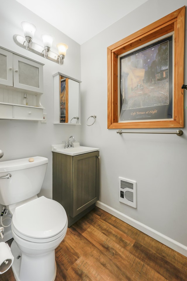 28503 Ottawa Dr, Browerville, MN 56438 - half bathroom featuring vanity, toilet, baseboards, wood finished floors, and heating unit