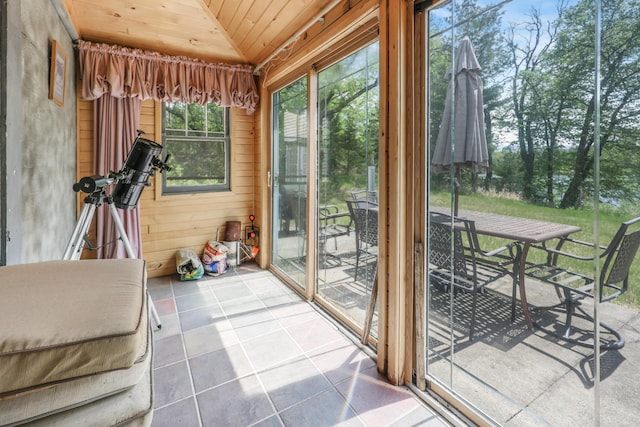 28503 Ottawa Dr, Browerville, MN 56438 - unfurnished sunroom featuring wood ceiling, vaulted ceiling, wooden walls, outdoor dining area, and tile patterned floors