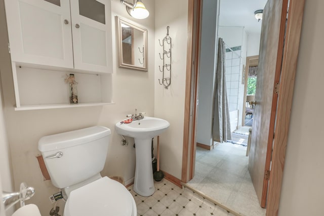 28503 Ottawa Dr, Browerville, MN 56438 - half bathroom featuring toilet, tile patterned floors, baseboards, and a sink