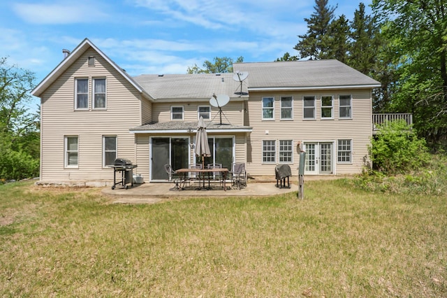 28503 Ottawa Dr, Browerville, MN 56438 - back of house featuring french doors, a lawn, a patio, and roof with shingles