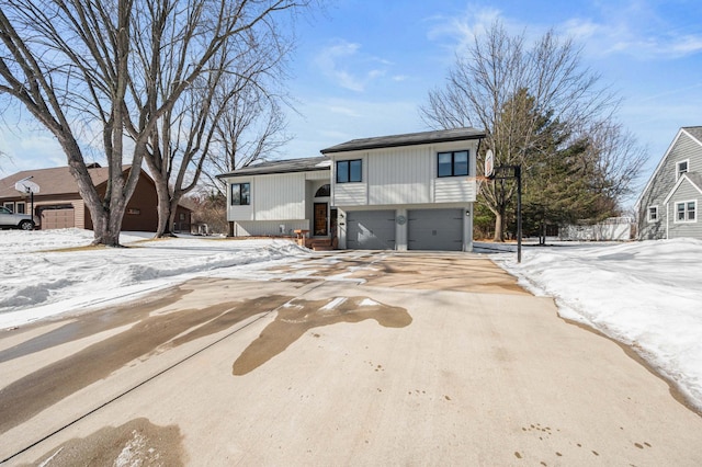 view of front facade with concrete driveway and a garage