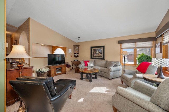 living area featuring carpet floors and vaulted ceiling