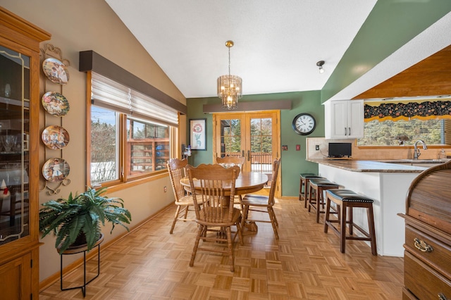 dining room featuring french doors, lofted ceiling, baseboards, and a chandelier