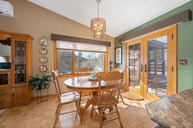 dining area with baseboards, lofted ceiling, french doors, an inviting chandelier, and a wall mounted AC