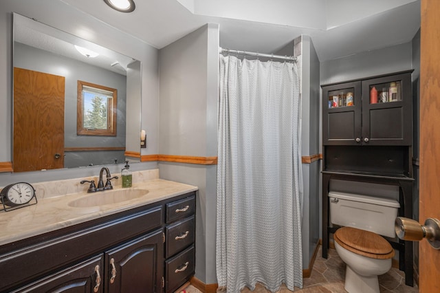 bathroom featuring vanity, a shower with shower curtain, and toilet