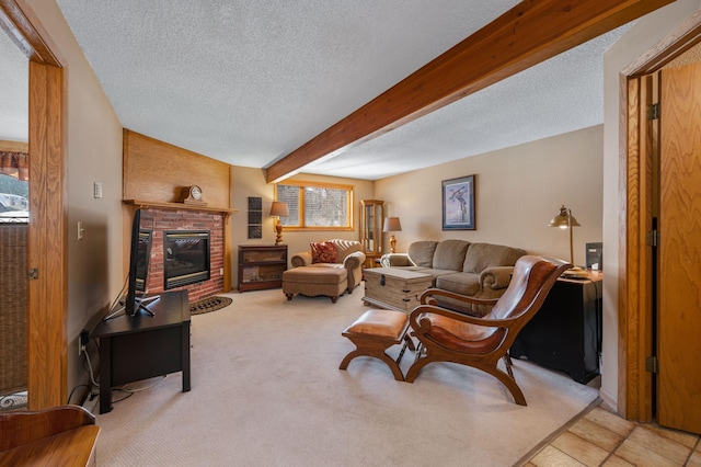 living area featuring beam ceiling, a fireplace, a textured ceiling, and carpet