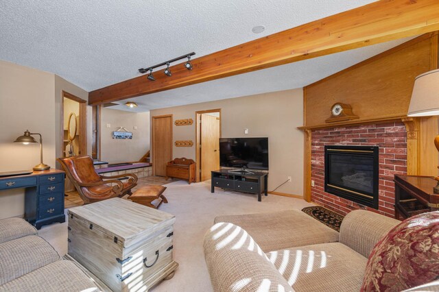 living room with stairway, beamed ceiling, light carpet, a fireplace, and a textured ceiling