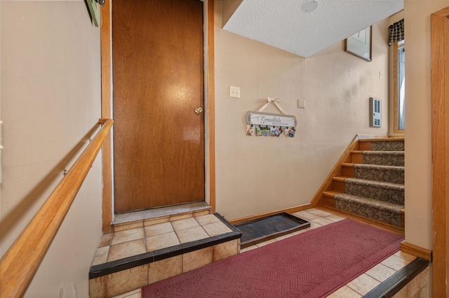 interior space with baseboards and a textured ceiling