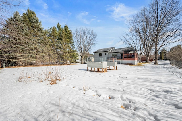 view of snow covered back of property