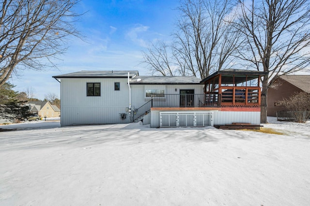 snow covered property featuring a wooden deck