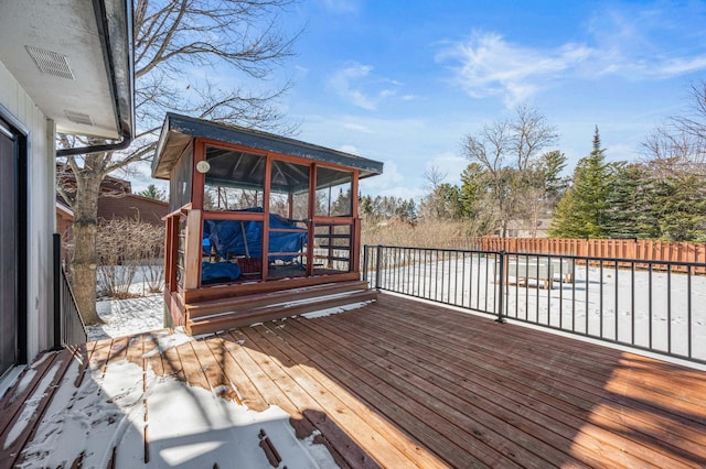 wooden terrace with fence and a sunroom