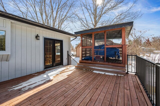 wooden deck featuring a sunroom