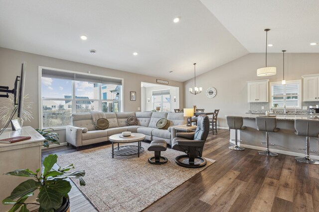 living area with recessed lighting, baseboards, lofted ceiling, and dark wood-type flooring