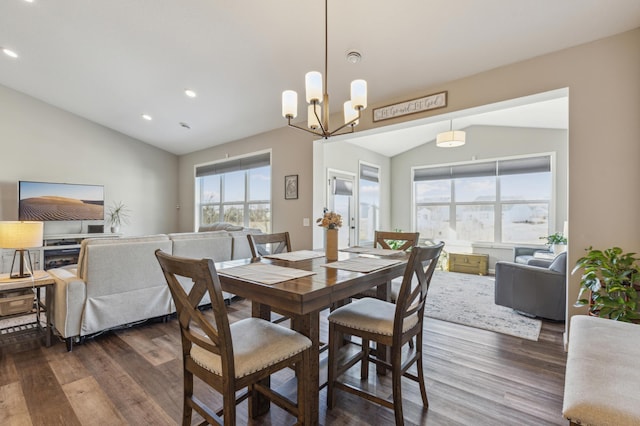 dining space with recessed lighting, wood finished floors, and vaulted ceiling