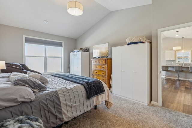 carpeted bedroom featuring lofted ceiling