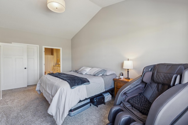 carpeted bedroom with ensuite bath and vaulted ceiling