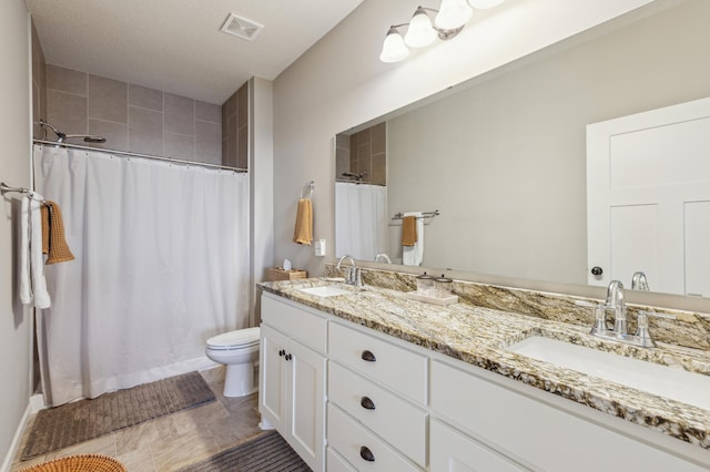 full bath with double vanity, visible vents, toilet, and a sink