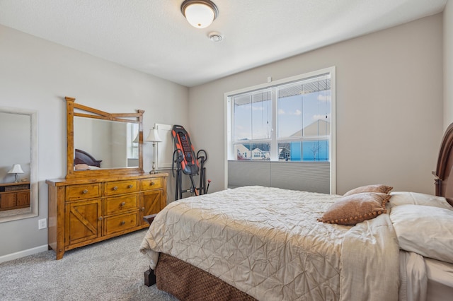 bedroom featuring baseboards and light colored carpet