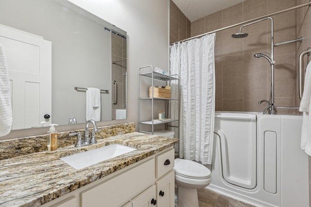 bathroom with curtained shower, toilet, and vanity