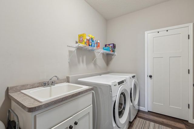 laundry area featuring dark wood-style floors, separate washer and dryer, a textured ceiling, and a sink