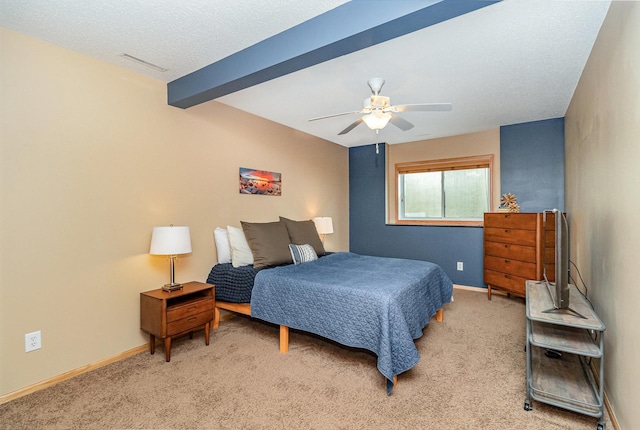 bedroom with light carpet, beam ceiling, visible vents, and baseboards