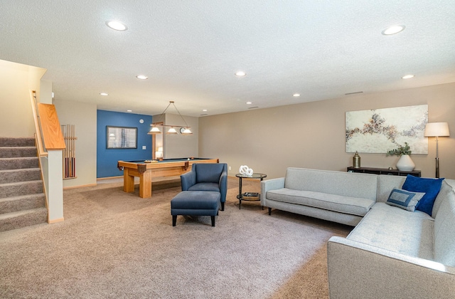 living area with pool table, a textured ceiling, stairs, and carpet floors