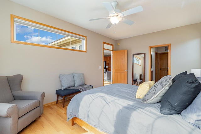 bedroom featuring baseboards, ceiling fan, and light wood finished floors