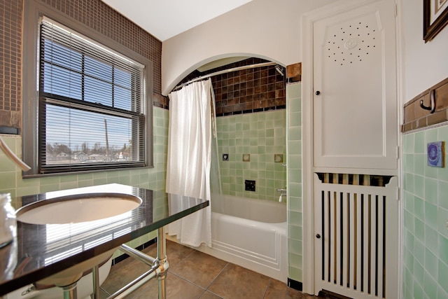 full bath featuring tile walls, shower / tub combo, and tile patterned flooring