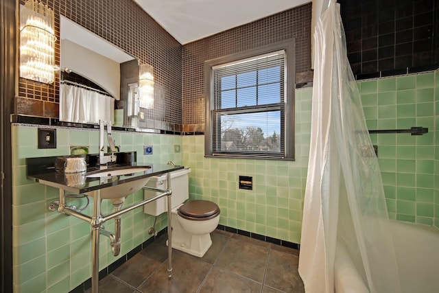 bathroom with toilet, tile walls, shower / tub combo, and tile patterned flooring