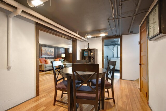 dining room featuring light wood-type flooring and washer / clothes dryer