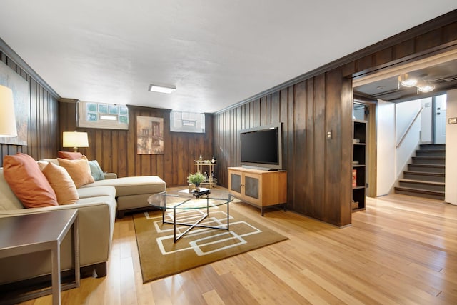 living room featuring stairs and light wood-style floors