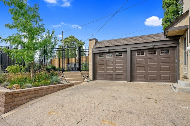 garage with a gate and fence