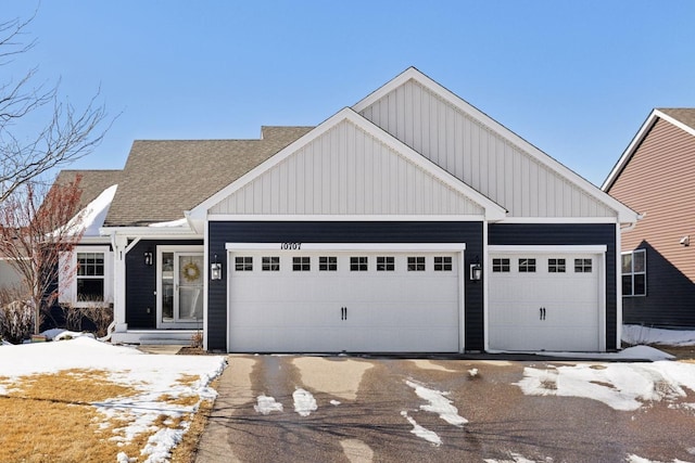 view of front of property featuring an attached garage, board and batten siding, and a shingled roof