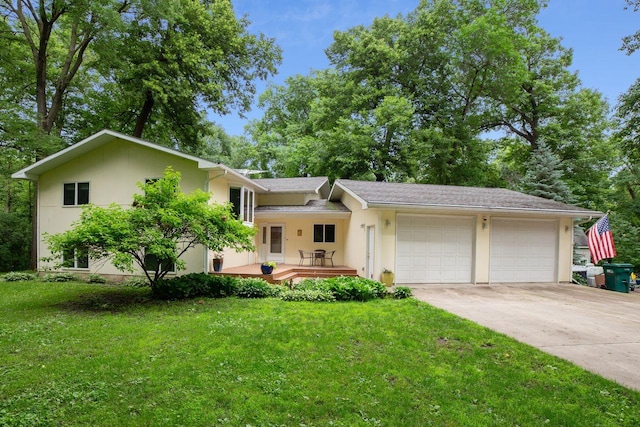 ranch-style house with stucco siding, a front lawn, concrete driveway, and an attached garage