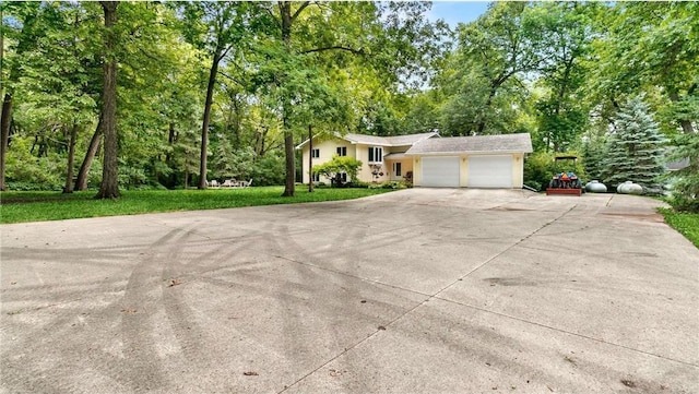 view of front of property with concrete driveway and an attached garage