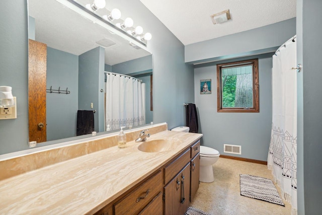 bathroom featuring visible vents, toilet, a textured ceiling, baseboards, and vanity