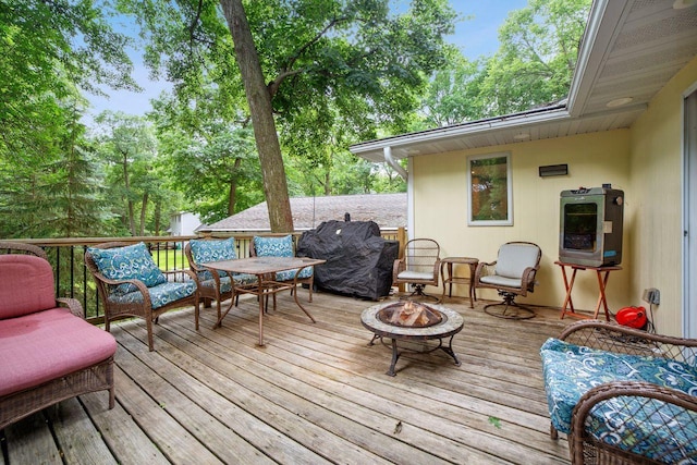 wooden terrace featuring an outdoor fire pit