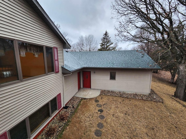 exterior space with roof with shingles