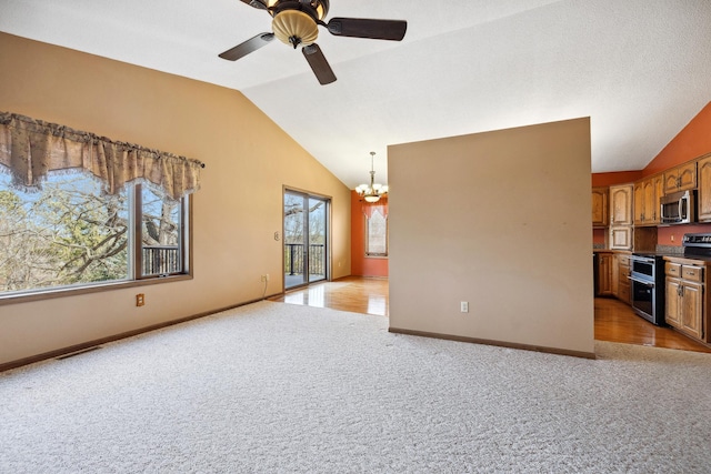 unfurnished living room with lofted ceiling, light colored carpet, baseboards, and visible vents