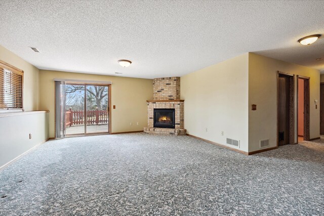 unfurnished living room featuring visible vents, carpet flooring, a fireplace, and baseboards