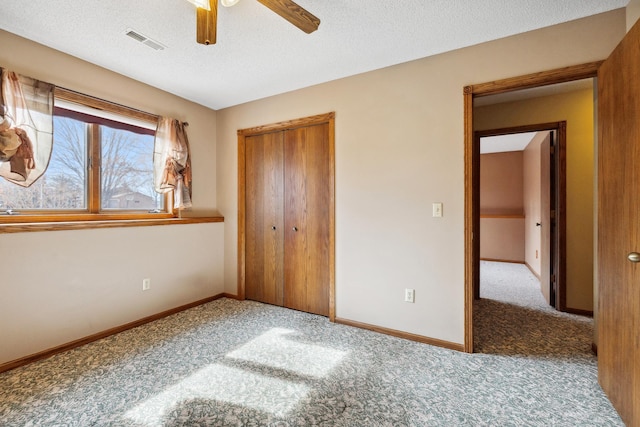 unfurnished bedroom featuring visible vents, baseboards, and carpet flooring